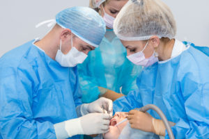 Dentists during surgery for implant placement