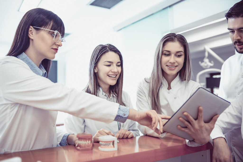 Young Medical Team Have Small Meeting at Clinics Reception Oral