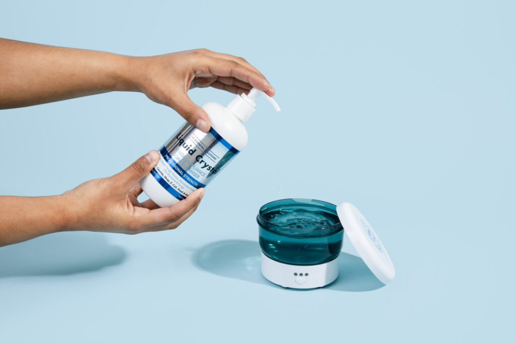 Liquid Crystal Soak Cleanser and Dr. B Ultrasonic Cleaner to disinfect dental appliance.