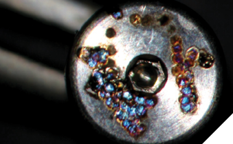 Damages to implant done by Nd:YAG 1,064 nm. Laser energy is strongly absorbed by titanium and can damage the implant even at low settings.