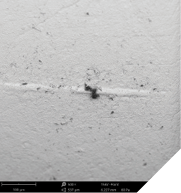 Images of a ceramic implant (SEM 500x + 2,500x) with particles of polysiloxanes caused by contact with the packaging; Advanced analytical techniques identified additional thin-film contamination with a cell-toxic quaternary ammonium compound.