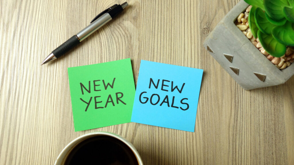 New Year goals concept with text handwritten on sticky notes in office
