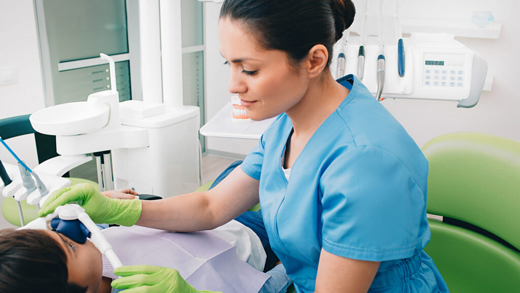 Pediatric dentist doing Inhalation Sedation to a child while teeth treatment at dental clinic. Sedation Dentistry