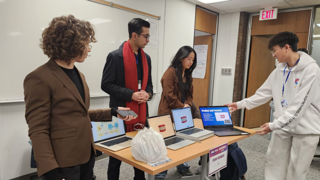 The third-place team presents its StarTooth patient-education app during the SmileHacks bioengineering competition. (Photo: Oral Health Group)